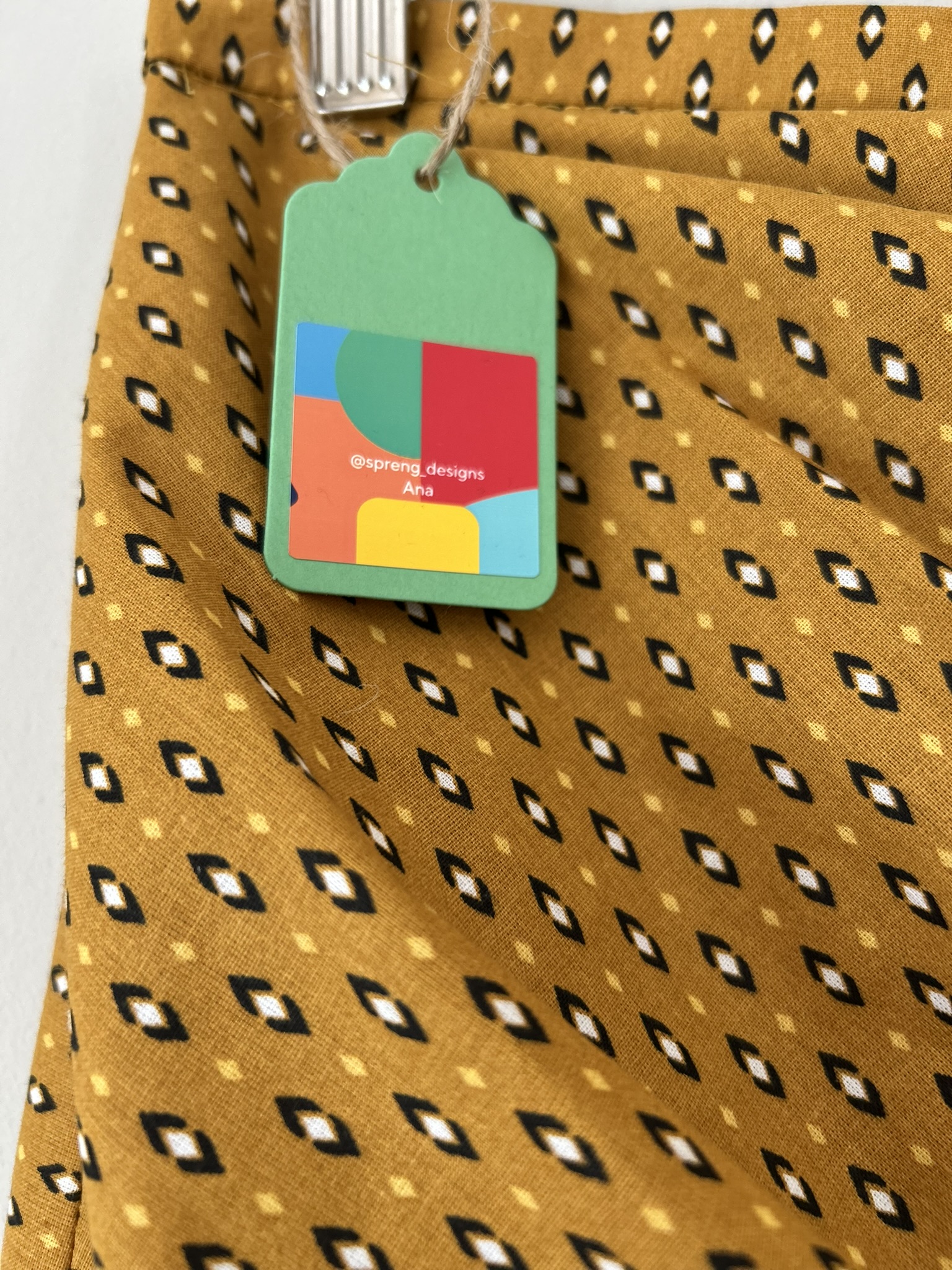 close up of the fabric and spreng designs label